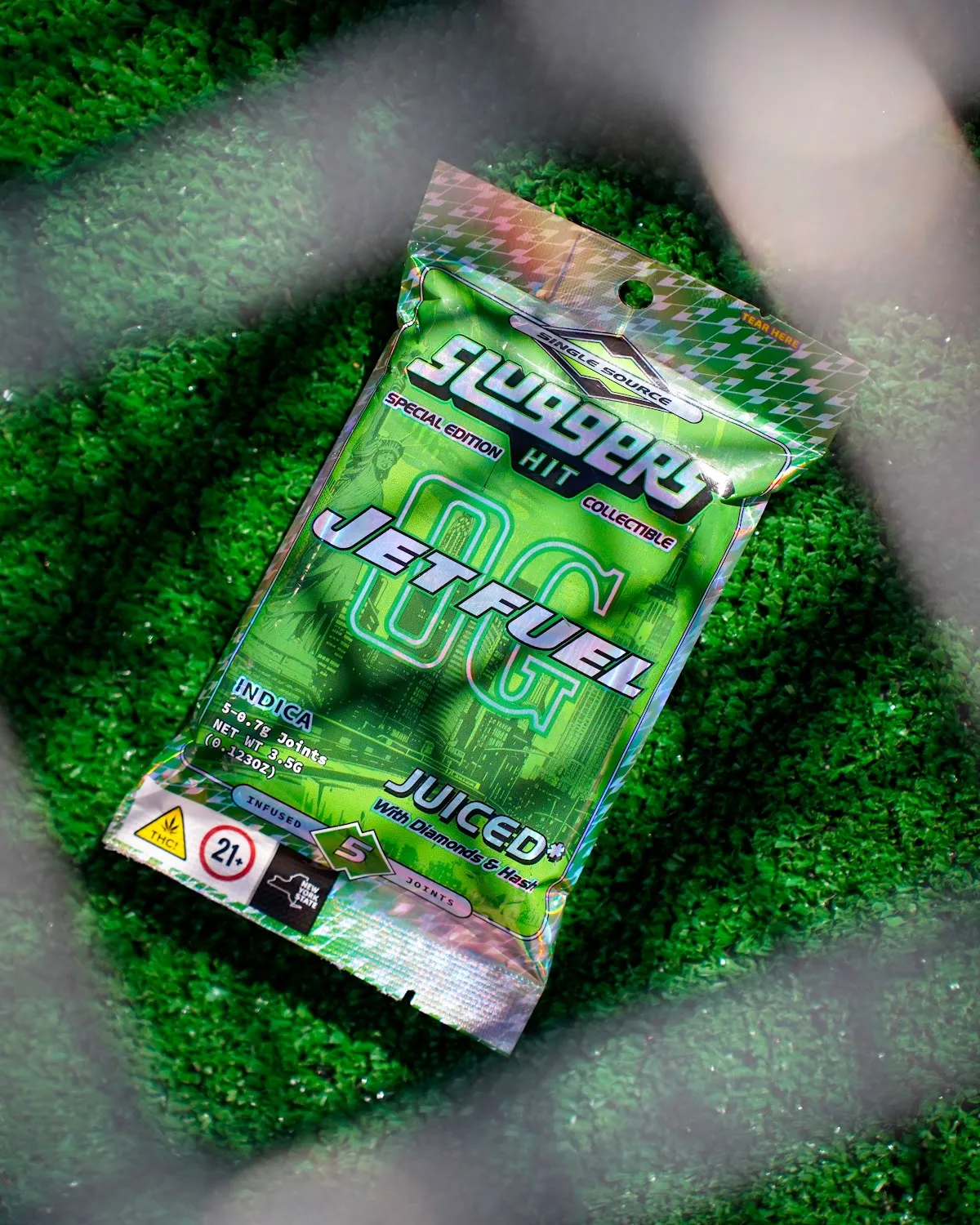 Cannabis pre-roll pack on green turf, cannabis product photography
