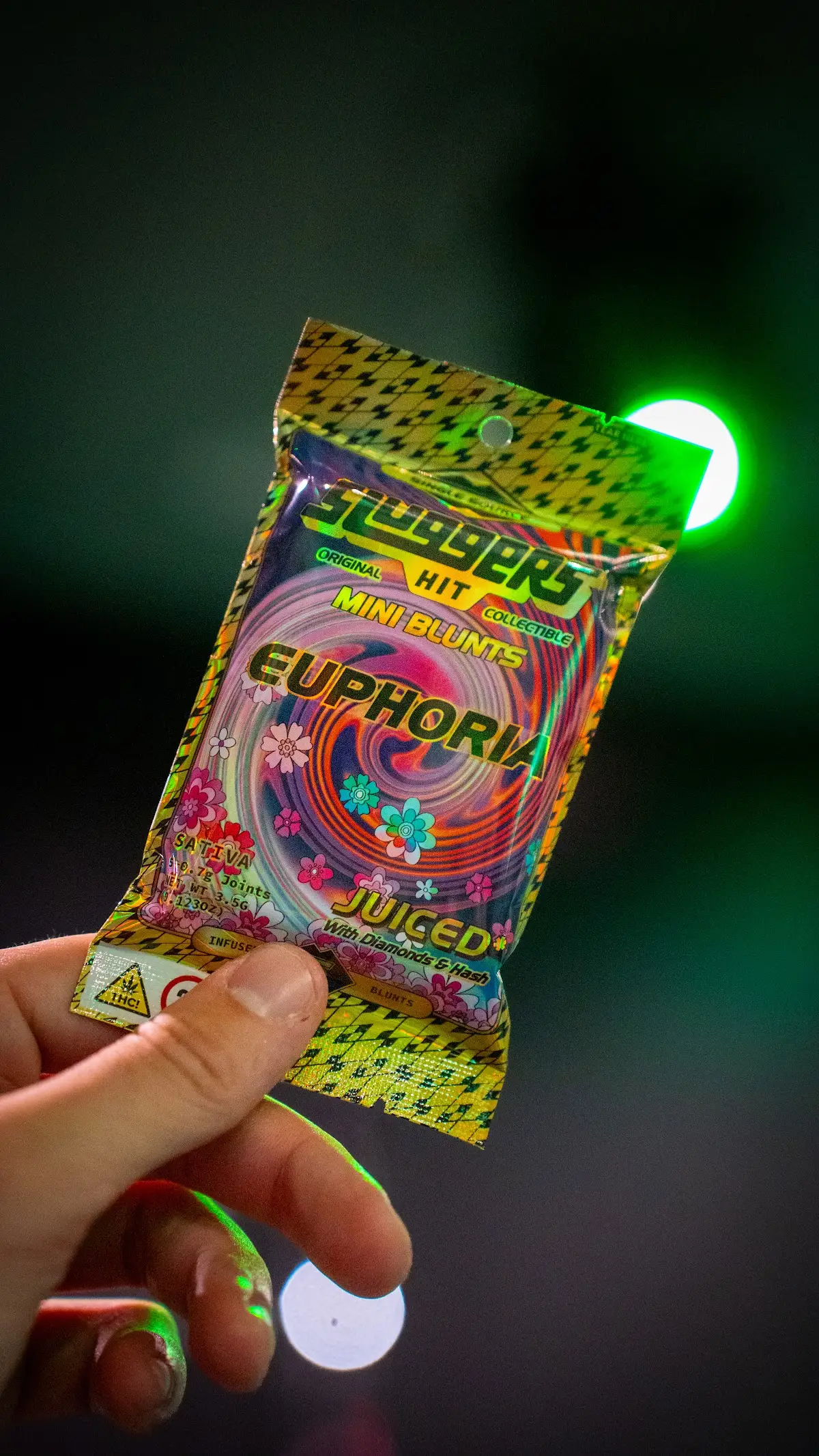 Mini blunts pack under neon light, cannabis product photography