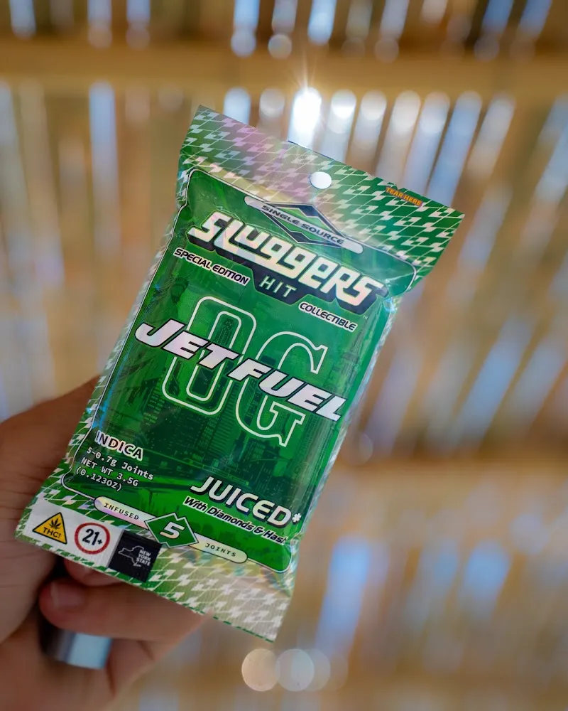 Holographic cannabis pre-roll pack held up, cannabis product photography