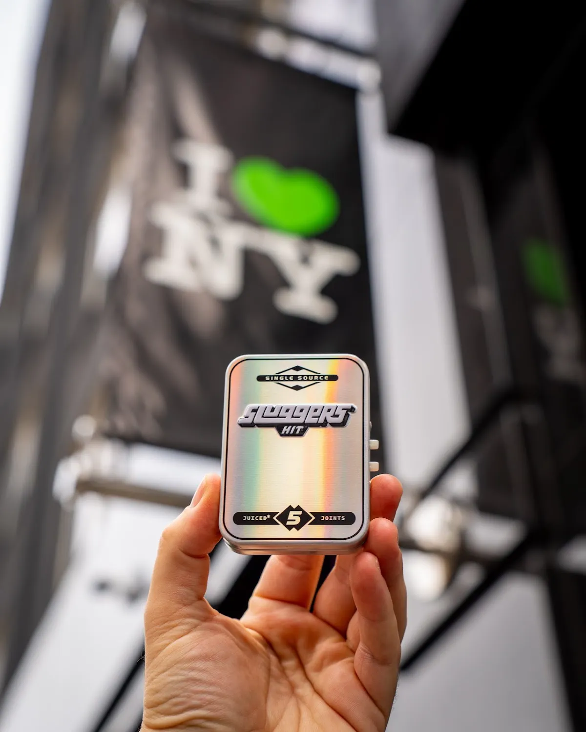Cannabis brand tin held outside New York dispensary, cannabis brand photography
