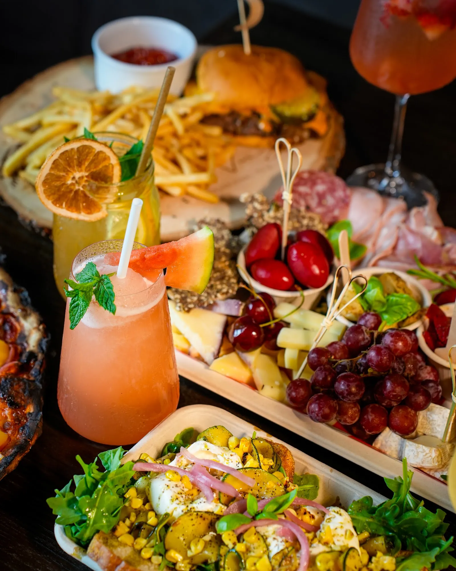 Full table spread with burgers, charcuterie and cocktails, restaurant photography Hudson Valley